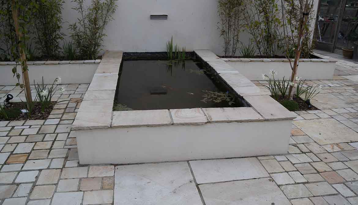 Formal fish pond with letterbox waterfall